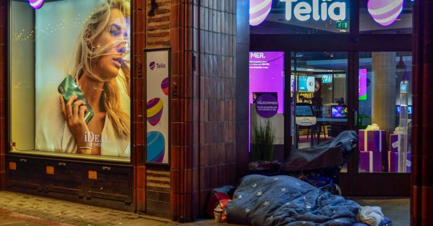 Boutique Hotels - Person Sleeping In Pavement Near Glass Window