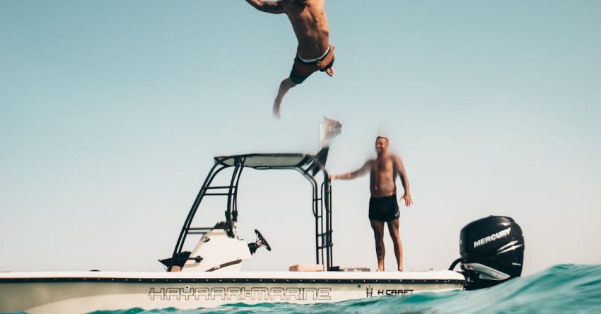 Yacht Cruise - Photo of Man Jumping from Boat to the Sea