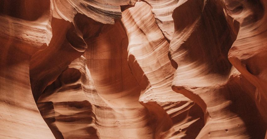 Canyoning - A photo of a narrow canyon with sand