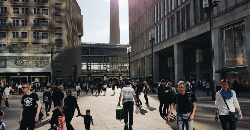 Shopping Districts - Man in Black Crew-neck T-shirt Walking Near Building